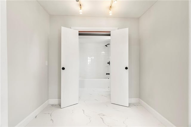 full bathroom with baseboards,  shower combination, and marble finish floor