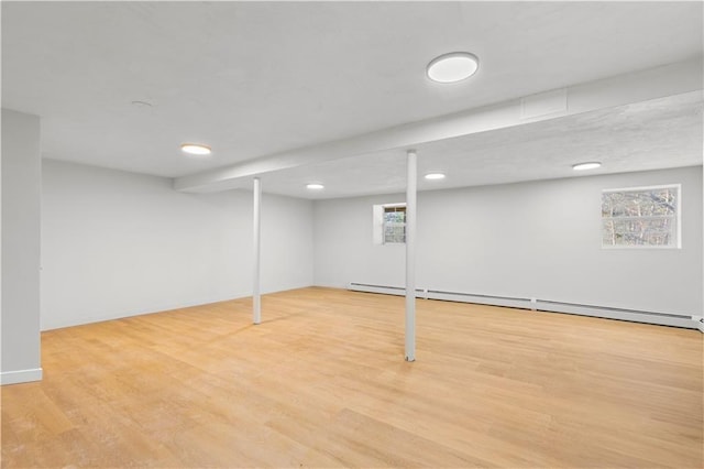 basement featuring recessed lighting, a healthy amount of sunlight, and wood finished floors