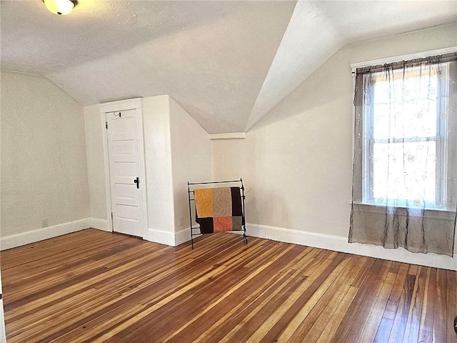 168 Spring St, Woonsocket, RI 02895 - additional living space with a textured ceiling, baseboards, vaulted ceiling, and hardwood / wood-style floors