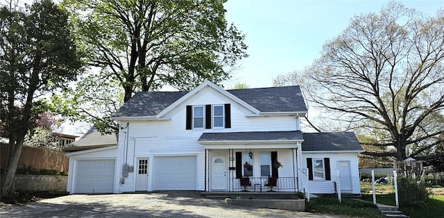 168 Spring St, Woonsocket, RI 02895 - view of front of property with a garage, covered porch, a shingled roof, and driveway