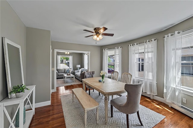 dining area featuring ceiling fan, plenty of natural light, baseboards, and wood finished floors