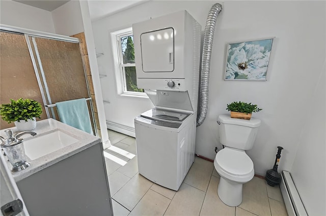 bathroom with tile patterned flooring, toilet, a baseboard heating unit, stacked washer and clothes dryer, and a stall shower