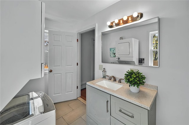 bathroom featuring vanity, stacked washer and dryer, and tile patterned floors