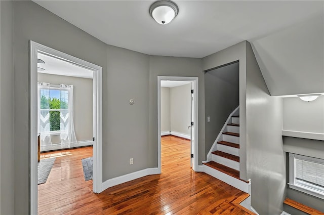 stairs with wood-type flooring and baseboards