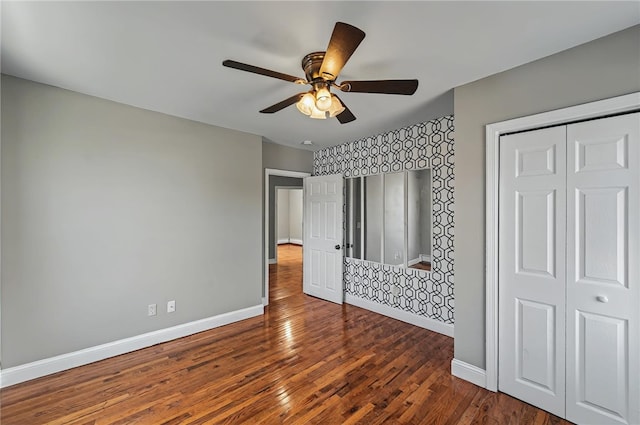 unfurnished bedroom with baseboards, ceiling fan, and wood finished floors