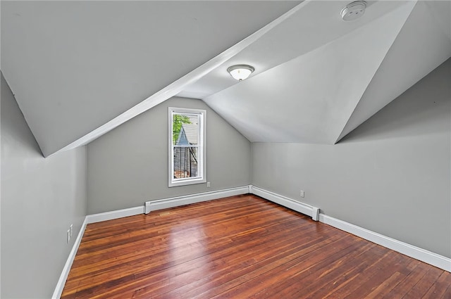 bonus room featuring baseboards, a baseboard heating unit, lofted ceiling, and hardwood / wood-style flooring