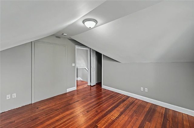 bonus room featuring wood-type flooring, baseboards, and lofted ceiling