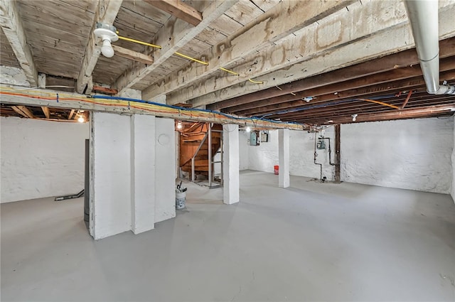 unfinished below grade area featuring stairway and electric panel