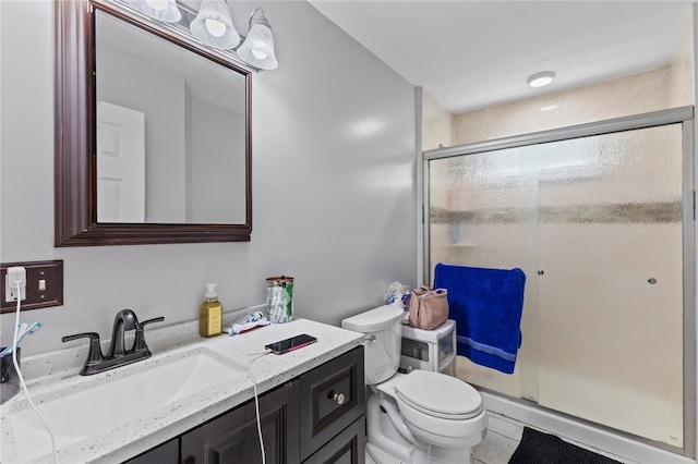 bathroom with vanity, tile patterned flooring, a stall shower, and toilet