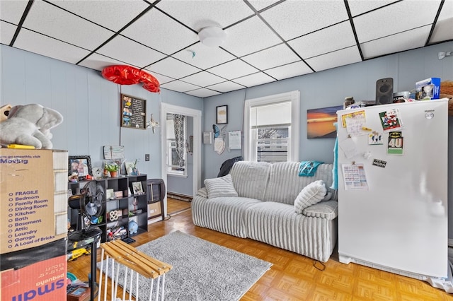 living room with a paneled ceiling