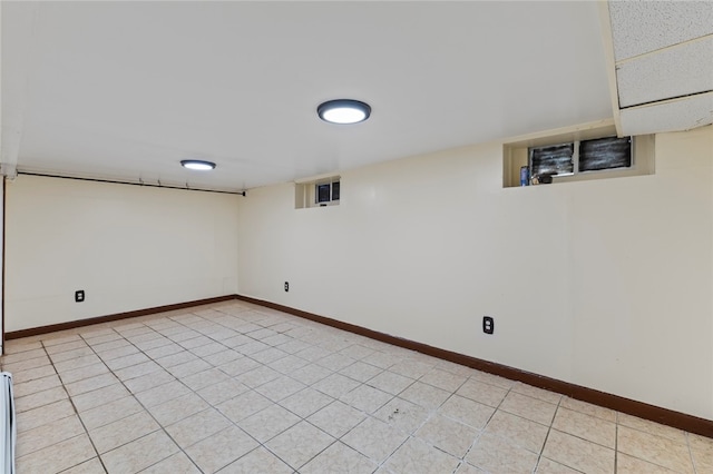 finished below grade area featuring baseboards and visible vents