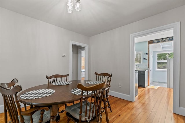 dining room featuring baseboards and light wood-style flooring