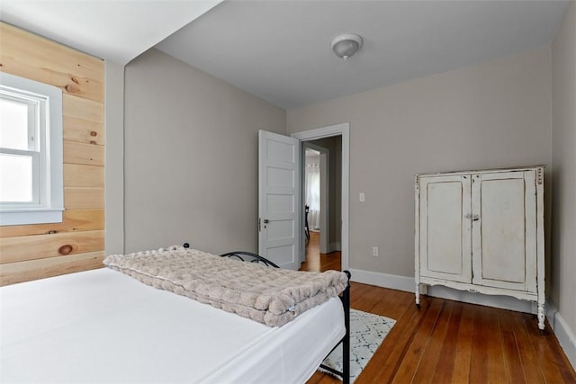 bedroom featuring baseboards and dark wood-style floors