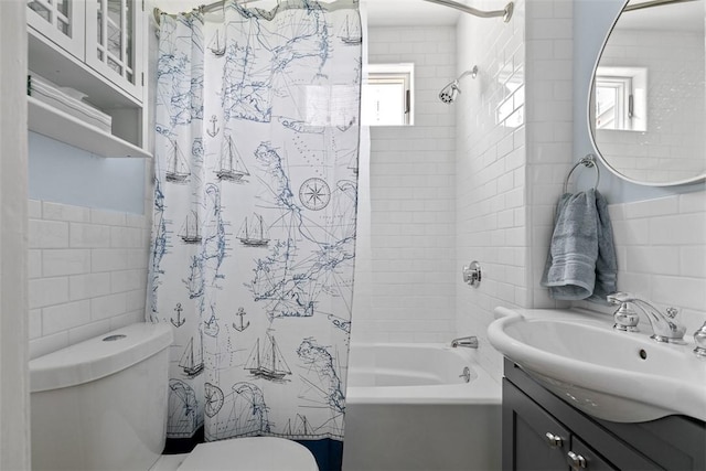 full bathroom featuring vanity, shower / tub combo with curtain, toilet, and tile walls