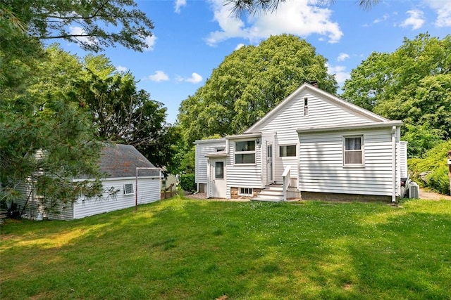 rear view of property featuring a yard