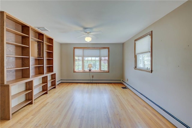 empty room featuring visible vents, ceiling fan, baseboard heating, light wood-type flooring, and a baseboard heating unit