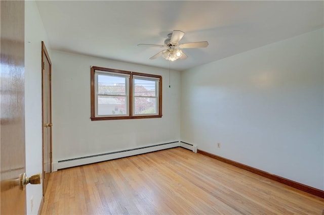 empty room featuring baseboards, a baseboard radiator, light wood-type flooring, and ceiling fan