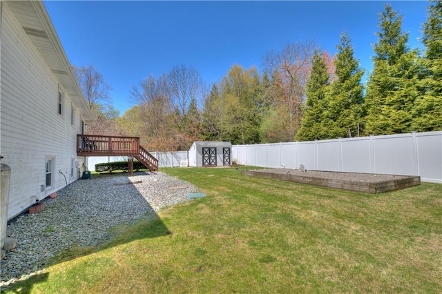 view of yard with stairs, a storage shed, a wooden deck, a fenced backyard, and an outdoor structure