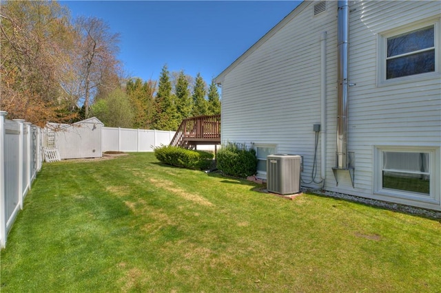 view of yard featuring a fenced backyard, a wooden deck, cooling unit, and stairway