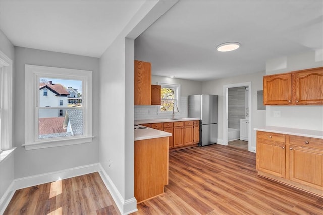 32 Summer St, Woonsocket, RI 02895 - kitchen featuring baseboards, freestanding refrigerator, a sink, and light countertops