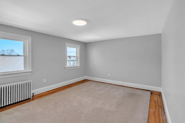 32 Summer St, Woonsocket, RI 02895 - empty room featuring wood finished floors, baseboards, and radiator heating unit