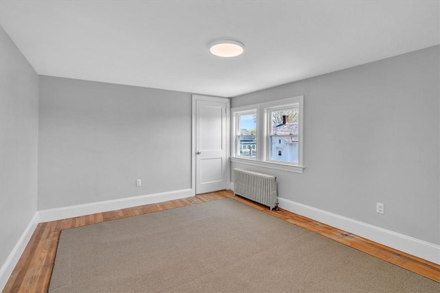 32 Summer St, Woonsocket, RI 02895 - unfurnished room featuring baseboards, wood finished floors, and radiator