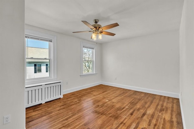 32 Summer St, Woonsocket, RI 02895 - unfurnished room with ceiling fan, radiator, baseboards, and wood finished floors