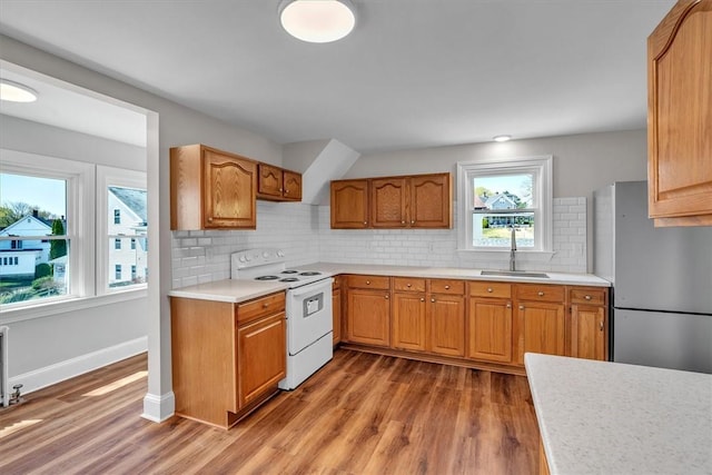 32 Summer St, Woonsocket, RI 02895 - kitchen featuring wood finished floors, a sink, light countertops, freestanding refrigerator, and white electric range oven