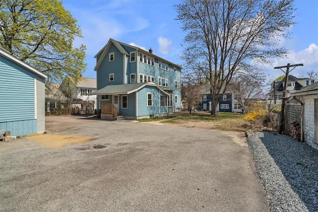 32 Summer St, Woonsocket, RI 02895 - rear view of house with a chimney