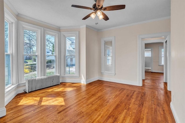 32 Summer St, Woonsocket, RI 02895 - empty room featuring radiator, baseboards, light wood-style flooring, and a wealth of natural light
