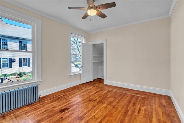 32 Summer St, Woonsocket, RI 02895 - spare room featuring baseboards, wood finished floors, and radiator