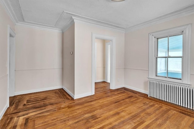32 Summer St, Woonsocket, RI 02895 - spare room featuring baseboards, ornamental molding, radiator heating unit, and wood finished floors