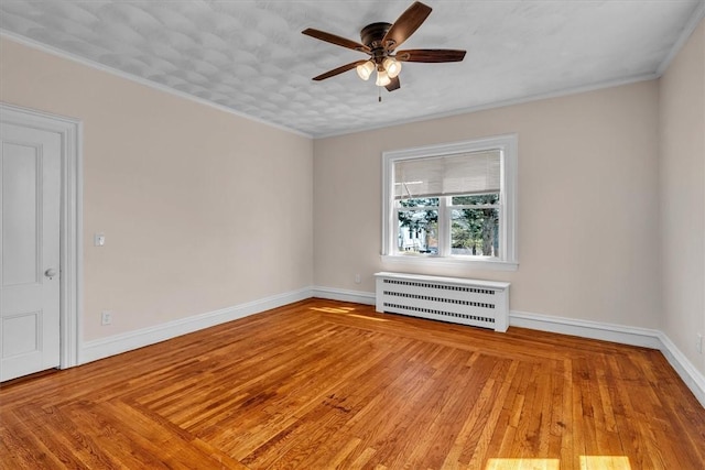 32 Summer St, Woonsocket, RI 02895 - unfurnished room with ceiling fan, radiator heating unit, baseboards, wood finished floors, and ornamental molding