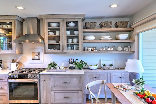 bar with recessed lighting, stainless steel gas stove, and wall chimney range hood