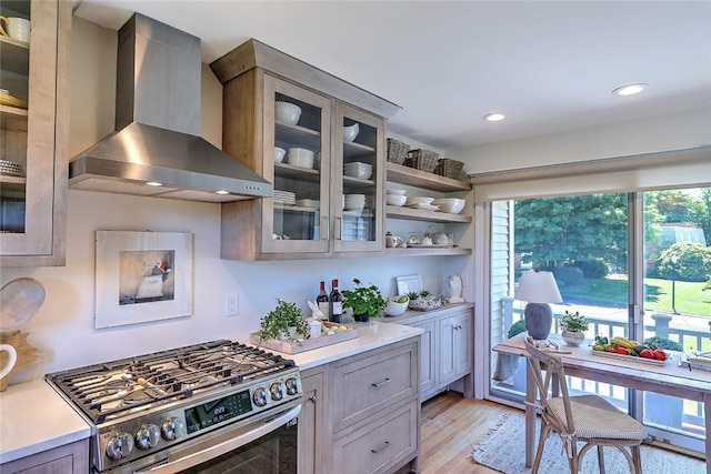 9 Hanley Farm Rd Unit 9, Warren, RI 02885 - kitchen featuring wall chimney exhaust hood, gas range, light countertops, glass insert cabinets, and recessed lighting