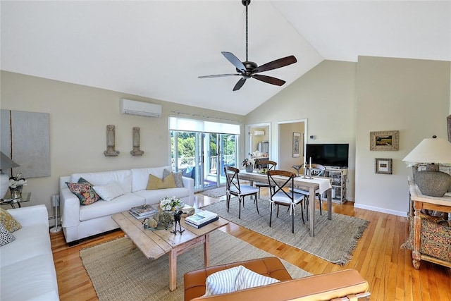 living room featuring high vaulted ceiling, a wall mounted AC, ceiling fan, and light wood-style floors