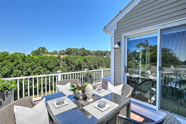 wooden terrace with outdoor dining area