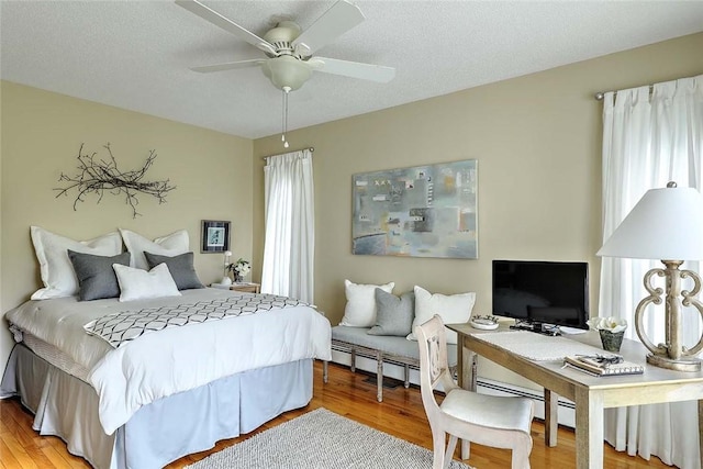 9 Hanley Farm Rd Unit 9, Warren, RI 02885 - bedroom featuring multiple windows, wood finished floors, and baseboard heating