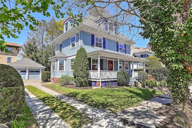 traditional style home featuring a porch, an outdoor structure, a front yard, and a garage