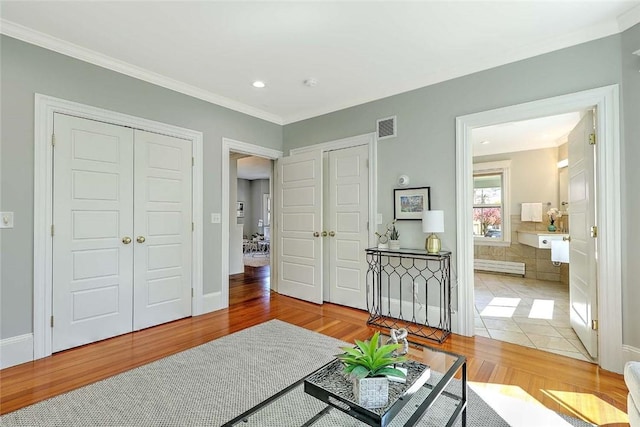 sitting room featuring visible vents, ornamental molding, wood finished floors, and recessed lighting