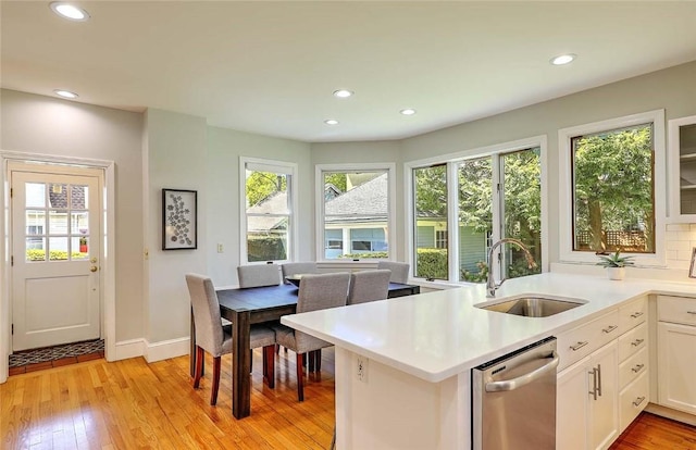 kitchen featuring recessed lighting, a sink, dishwasher, and a healthy amount of sunlight