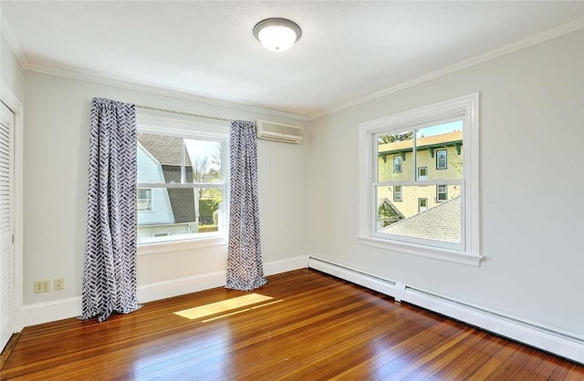 spare room with a healthy amount of sunlight, a baseboard radiator, wood-type flooring, and an AC wall unit