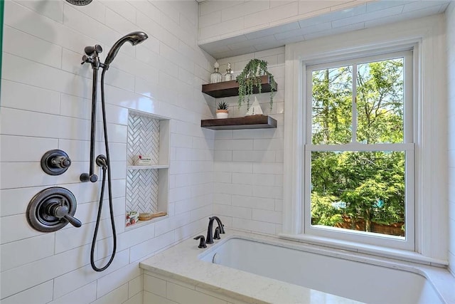 full bathroom with a bathing tub and a tile shower