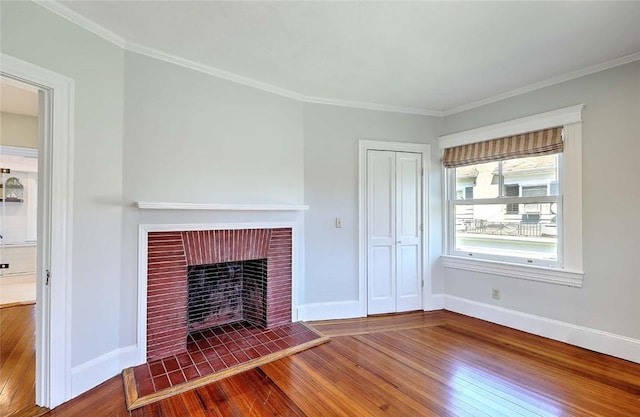 unfurnished living room featuring crown molding, baseboards, wood-type flooring, and a fireplace