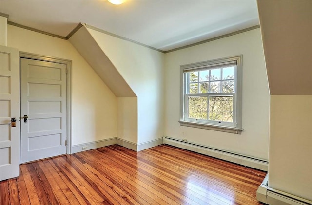 bonus room featuring a baseboard radiator, vaulted ceiling, and hardwood / wood-style floors