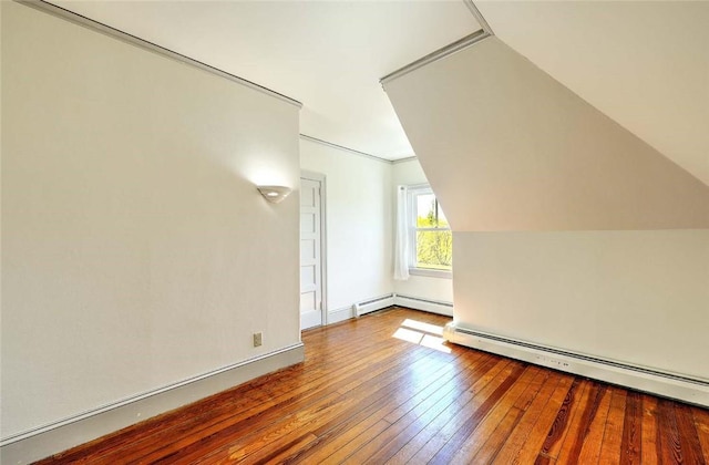 bonus room with a baseboard radiator and hardwood / wood-style floors