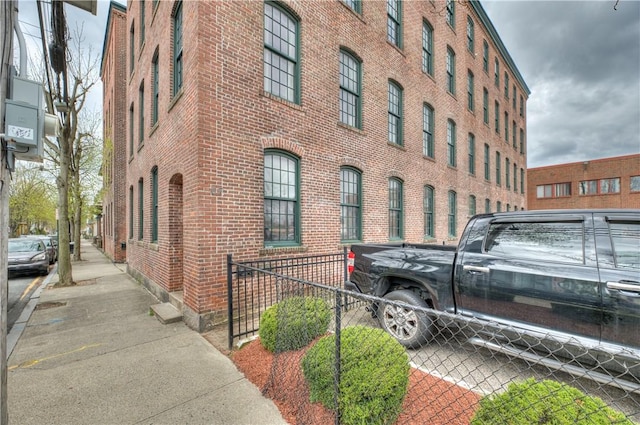view of building exterior with fence