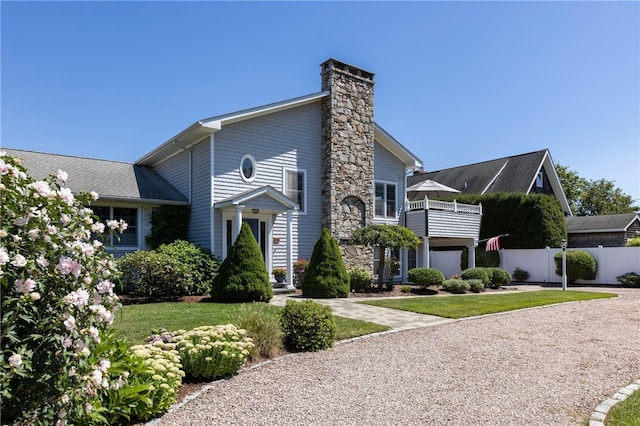 16 Central St, Charlestown, RI 02813 - view of front facade featuring fence, a chimney, and a balcony
