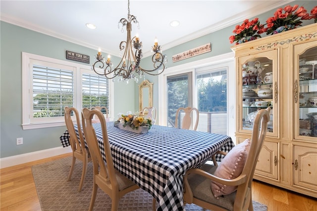 16 Central St, Charlestown, RI 02813 - dining room with crown molding, a wealth of natural light, light wood-type flooring, and a notable chandelier