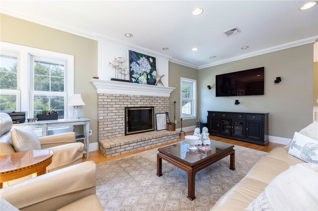 16 Central St, Charlestown, RI 02813 - living room featuring visible vents, ornamental molding, wood finished floors, a fireplace, and baseboards